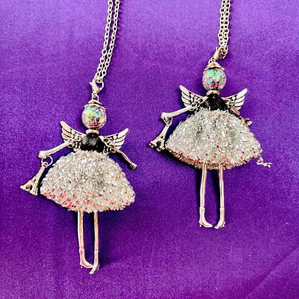 A metal 3 & 3/4” Angel on a 28” chain.